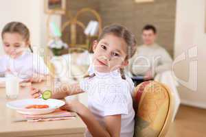 little girl at home having meal