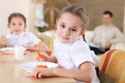 little girl at home having meal