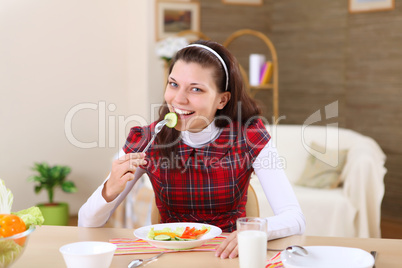 young girl eating healthy food at home