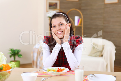 young girl eating healthy food at home