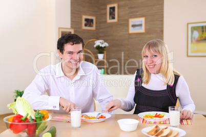 young couple at home having meal