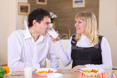 young couple at home having meal