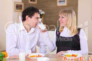 young couple at home having meal