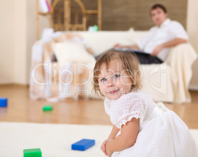 little girl playing on the floor at home