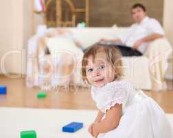 little girl playing on the floor at home