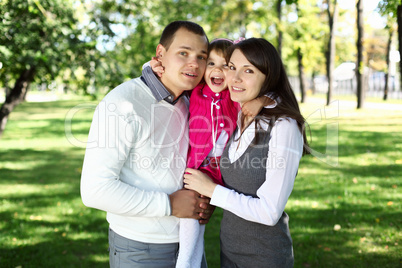 Young family with a child in summer park