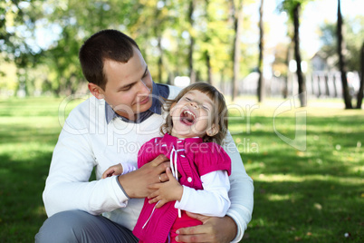 Young family with a child in summer park