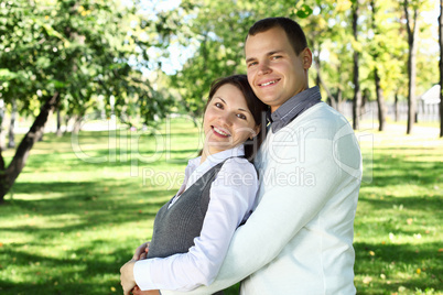 Young family with a child in summer park