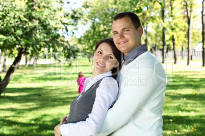 Young family with a child in summer park