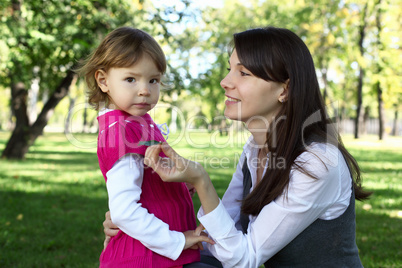 Mother with her daughter in summer park