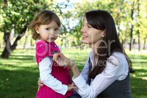 Mother with her daughter in summer park