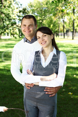 Young family with a child in summer park