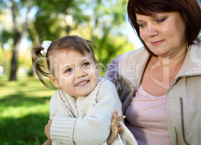 Grandmother with her little granddaghter in park