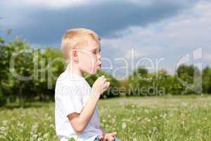 litlle boy with dandelion