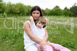 itlle girl with her mother outdoors