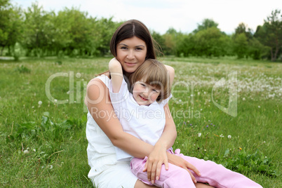 itlle girl with her mother outdoors