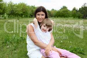 itlle girl with her mother outdoors