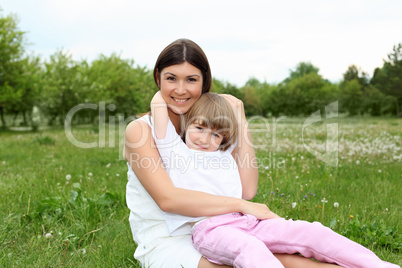 itlle girl with her mother outdoors