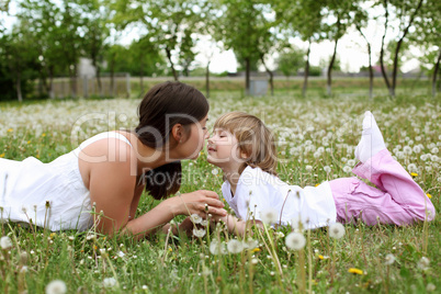 itlle girl with her mother outdoors