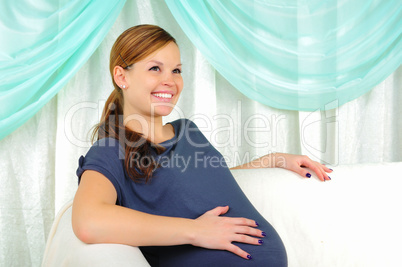 Portrait of a young pregnant girl