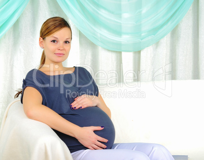 Portrait of a young pregnant girl