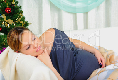 Pregnant woman lying on a sofa