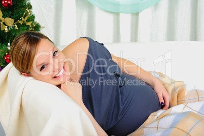 Pregnant woman lying on a sofa