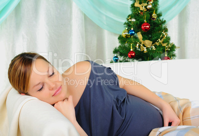 Pregnant woman lying on a sofa