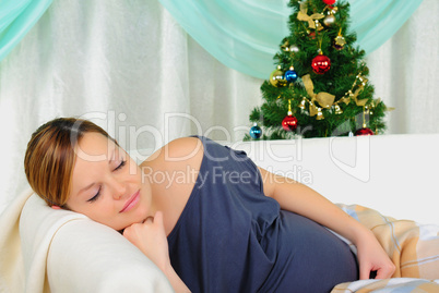 Pregnant woman lying on a sofa