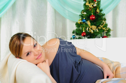 Pregnant woman lying on a sofa