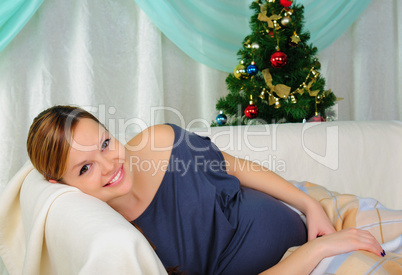 Pregnant woman lying on a sofa