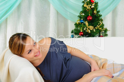 Pregnant woman lying on a sofa