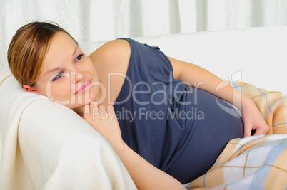 Pregnant woman lying on a sofa