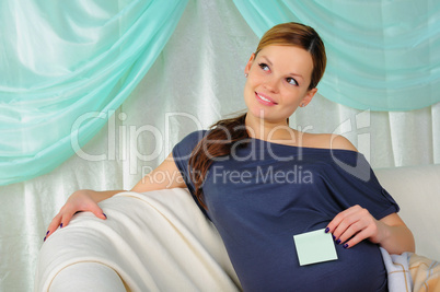 Pregnant woman lying on a sofa