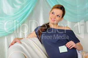 Pregnant woman lying on a sofa