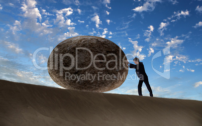 Businessman rolling a giant stone