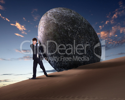 Businessman rolling a giant stone