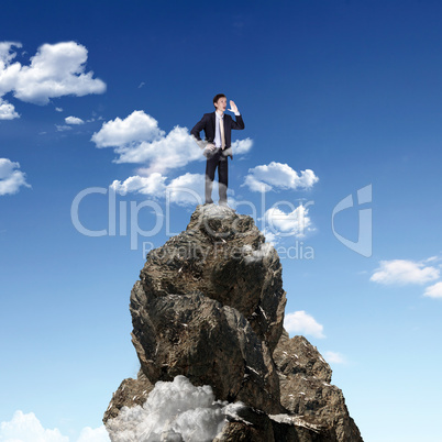 Businessman on the top of a high mountain