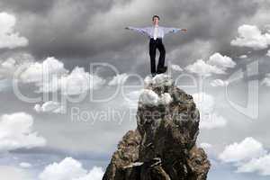 Businessman on the top of a high mountain