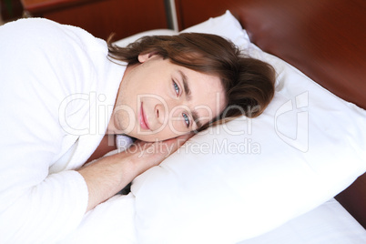 portrait of a young man in bed