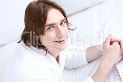 portrait of a young man in bed