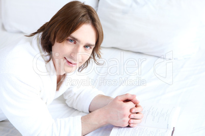 portrait of a young man in bed