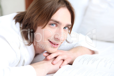 portrait of a young man in bed