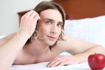 portrait of a young man in bed