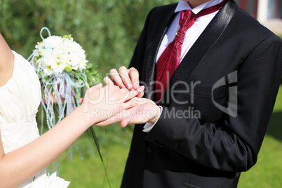 Shot moment when the groom puts the ring