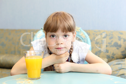 portrait of little girl with orange juice