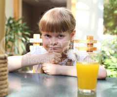 portrait of little girl with orange juice
