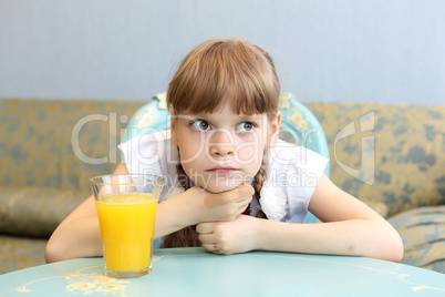 portrait of little girl with orange juice