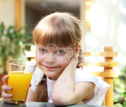 portrait of little girl with orange juice