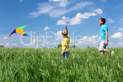 father with son in summer with kite